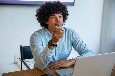 Confident Businessman Gesturing During Virtual Meeting