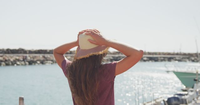 Woman Enjoying Day at Marina Wearing Summer Hat - Download Free Stock Images Pikwizard.com