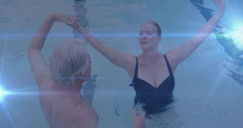 Senior Couple Embracing Wellness During Pool Dance