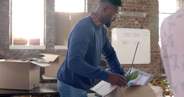 Man Packing Office Belongings in Coworking Space - Download Free Stock Images Pikwizard.com