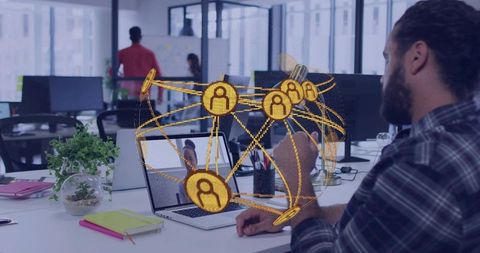 Bearded man connecting with team using holographic network over laptop in modern office