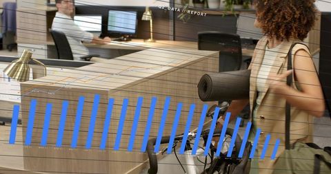 Professional carrying yoga mat and bicycle through open-plan office with data overlay