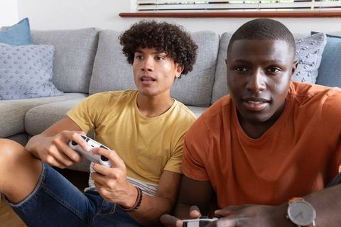 Diverse Friends Enjoying Video Games in Stylish Living Room Setting