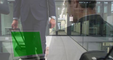 Businessman with Green Screen Laptop in Corporate Environment