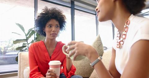Diverse professionals chatting in modern office lounge