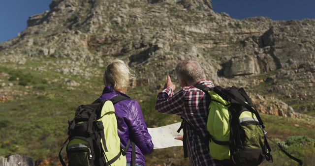 Senior Couple Backpacking and Navigating with a Map in Mountain Terrain - Download Free Stock Images Pikwizard.com
