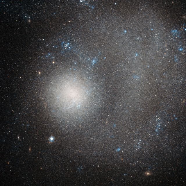 Image depicts NGC 5474, a dwarf galaxy located 21 million light-years away in the constellation Ursa Major. Taken by Hubble's Advanced Camera for Surveys, this galaxy exhibits stunning cosmic features with billions of stars. Great for use in educational content, astronomy articles, and science presentations demonstrating galaxies, space phenomena, and Hubble's capabilities.