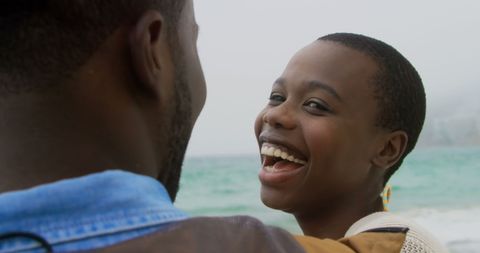 Joyful Couple Enjoying Ocean View on Beach