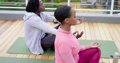 Rooftop Couple Meditating on Yoga Mats Practicing Mindfulness and Relaxation Outdoors