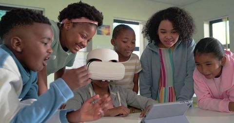 Multiracial Kids Exploring Virtual Reality Together in Classroom STEM Technology Activity