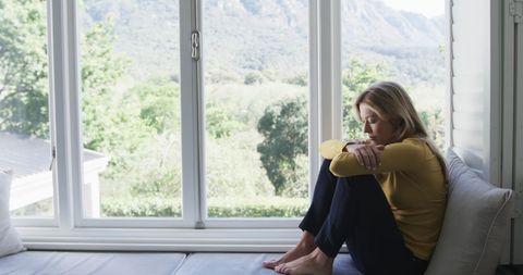 Thoughtful Woman Sitting by Window Relaxing - Download Free Stock Images Pikwizard.com