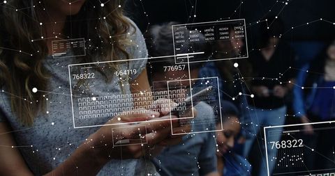 Mid-adult woman holding smartphone with futuristic HUD overlays in dim lecture hall