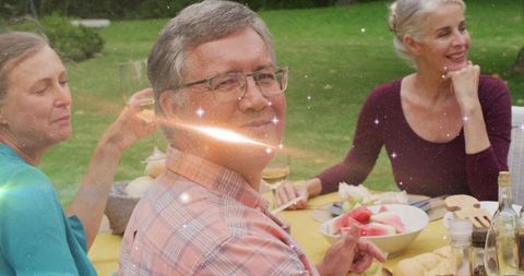 Friends Enjoying Outdoor Meal in Lush Garden Setting