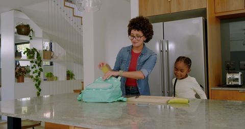 Mother Daughter Morning Routine with Backpack in Modern Kitchen
