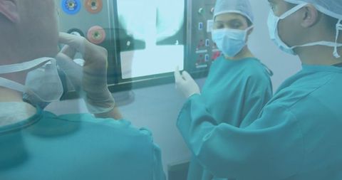Medical Team Analyzing Data on Monitors in Operating Room