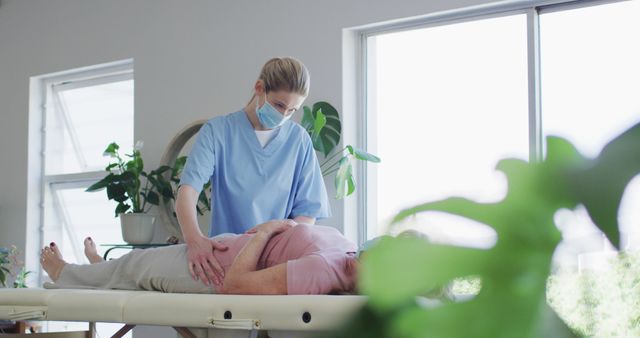 Female Nurse Treating Patient during Reflexology Session in Bright Room - Download Free Stock Images Pikwizard.com