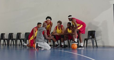 Basketball coach motivating team during halftime