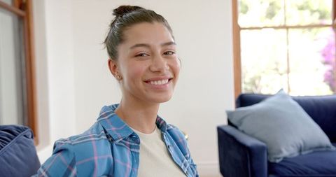 Smiling Teen in Sunny Living Room Indoor Lifestyle - Download Free Stock Images Pikwizard.com