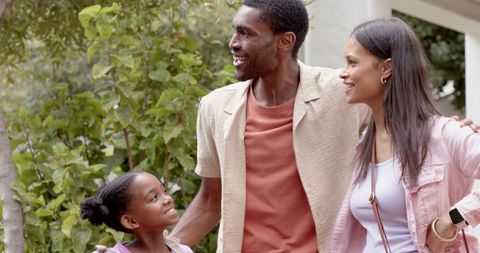 Happy Family Enjoying Day Outdoors in Residential Area