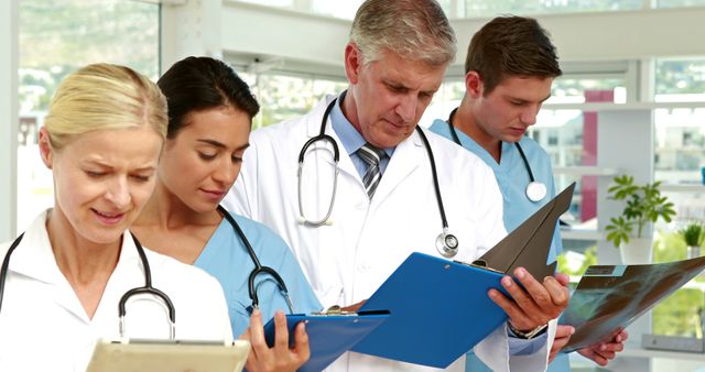 Healthcare Team Discussing Patient Charts in Hospital - Download Free Stock Images Pikwizard.com