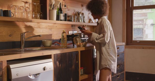 Woman Preparing Breakfast in Cozy Kitchen with Wooden Interiors - Download Free Stock Images Pikwizard.com