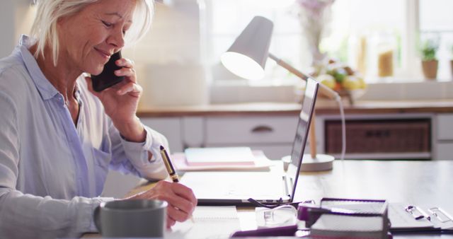 Senior Woman Working from Home, Talking on Phone, Taking Notes - Download Free Stock Images Pikwizard.com