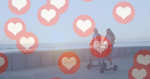 Social Media Hearts over Couple on Scooters by Seaside