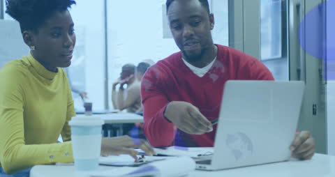 Business Professionals Analyzing Data on Laptop with Futuristic Interface
