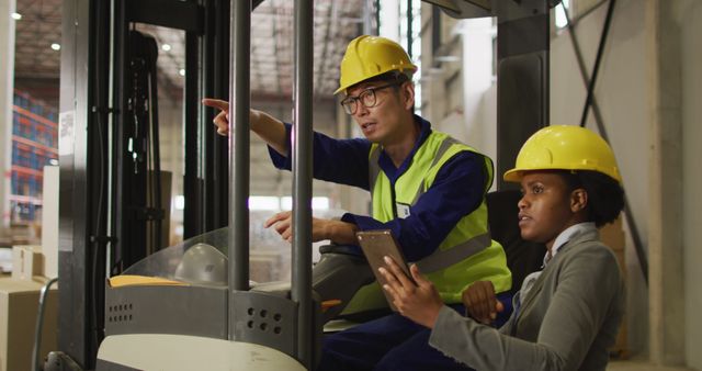 Warehouse Workers Discussing Logistics on Forklift - Download Free Stock Images Pikwizard.com