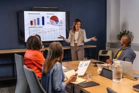 Business team presenting quarterly growth charts in modern conference room