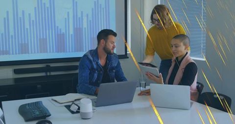 Team Collaborating Over Analytics Presentation in Modern Office Boardroom