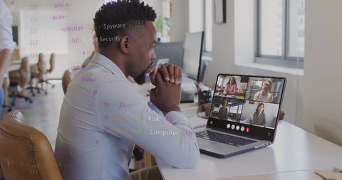 Businessman engaging in virtual meeting with digital code overlay