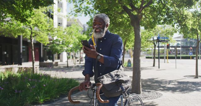 Smiling Senior Man Checking Smartphone While Biking in Urban Park - Download Free Stock Images Pikwizard.com
