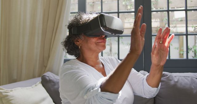 Senior Woman Using VR Headset Sitting on Couch - Download Free Stock Images Pikwizard.com