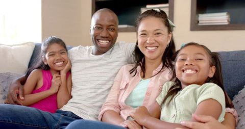 Smiling Mixed-Race Family Enjoying Cozy Time at Home