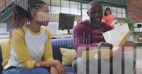 Team Collaboration with Digital Data Display in Modern Office