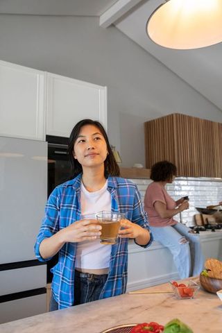 Diverse Female Friends Relaxing in Modern Kitchen