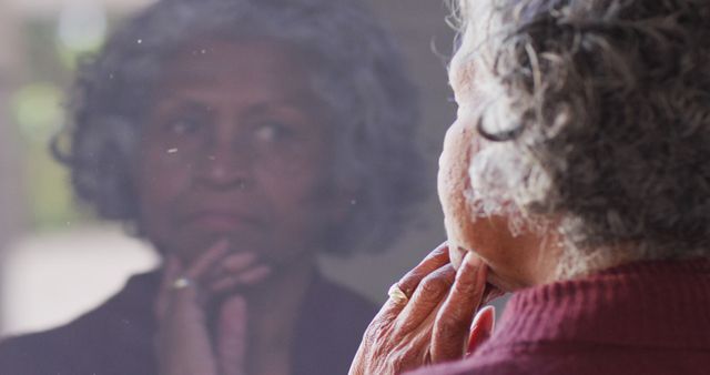 Senior Woman Reflecting in Mirror, Deep in Thought - Download Free Stock Images Pikwizard.com