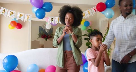 Family Celebrating Birthday with Balloons at Home Gathering