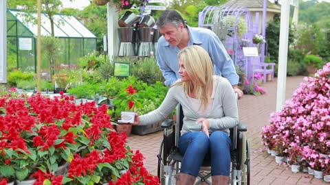 Garden Center Exploration with Couple Examining Flowers
