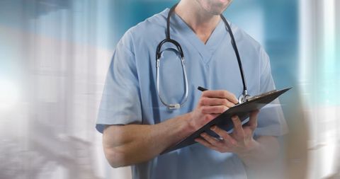 Doctor Writing on Clipboard in Hospital Setting