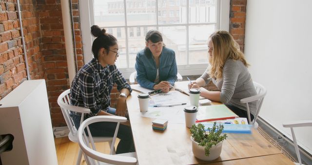 Diverse Group Collaborating at Table in Modern Office - Download Free Stock Images Pikwizard.com