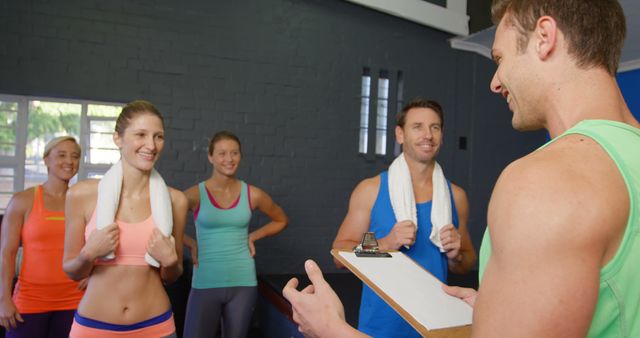 Personal Trainer with Group of Smiling Adults in Gym Wearing Sportswear - Download Free Stock Images Pikwizard.com