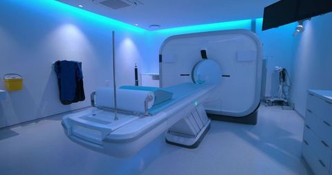 Advanced mri gantry room featuring sliding patient table and calming blue ambient lighting