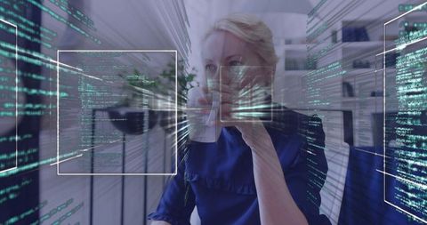 Professional woman sipping coffee while analyzing augmented reality code interface