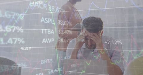 Stressed businessman analyzing stock market data at workplace