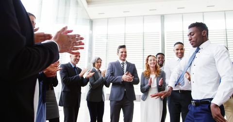 Excited Business Team Applauding Dancing Colleague in Office Party - Download Free Stock Images Pikwizard.com