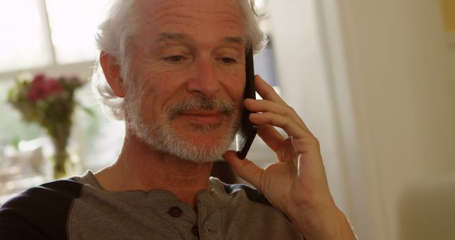 Senior Man Smiling While Talking On Smartphone At Home - Download Free Stock Images Pikwizard.com