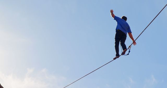 Man Balancing on Tightrope Against Clear Blue Sky - Download Free Stock Images Pikwizard.com