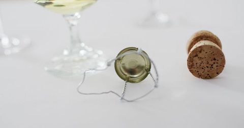 Champagne cork and glass on elegant white surface